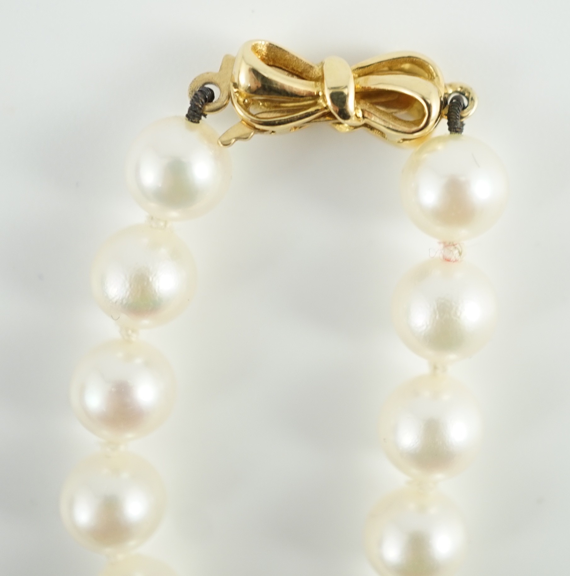 A late 1990's single strand cultured pearl and diamond cluster set necklace